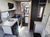 Interior of Challenger 560 SE, showing kitchen and looking towards the front of the caravan