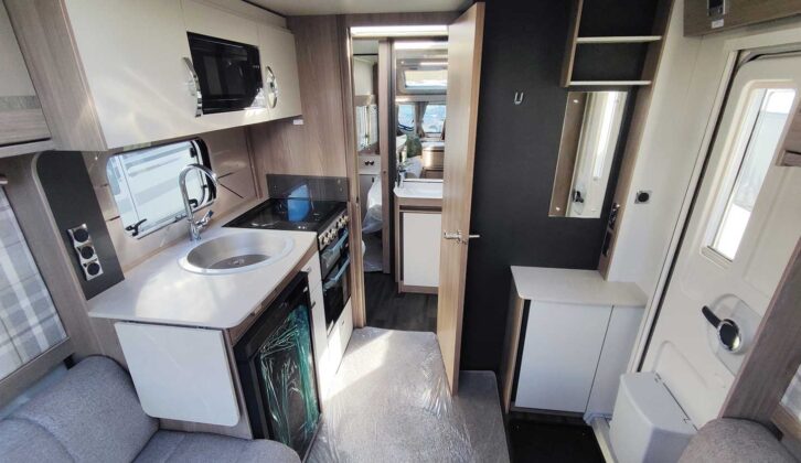 Interior of Challenger 560 SE, showing kitchen and looking towards the front of the caravan