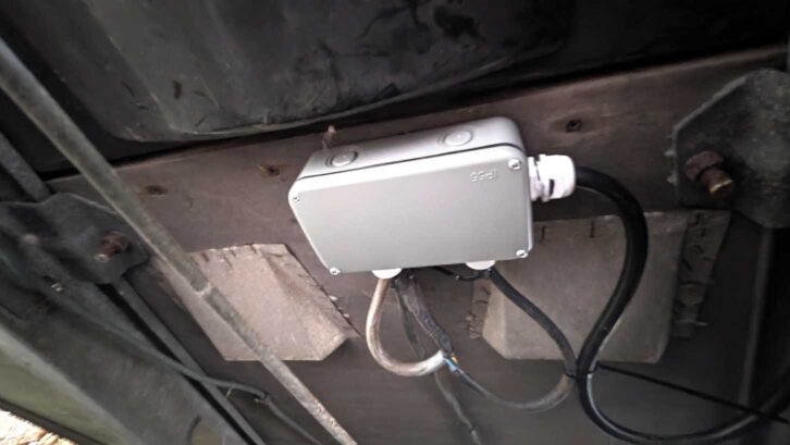 Waterproof box secured to the floor and cables in place