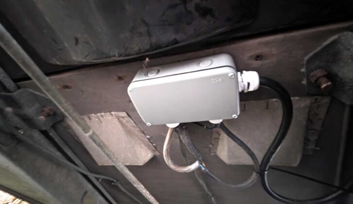 Waterproof box secured to the floor and cables in place