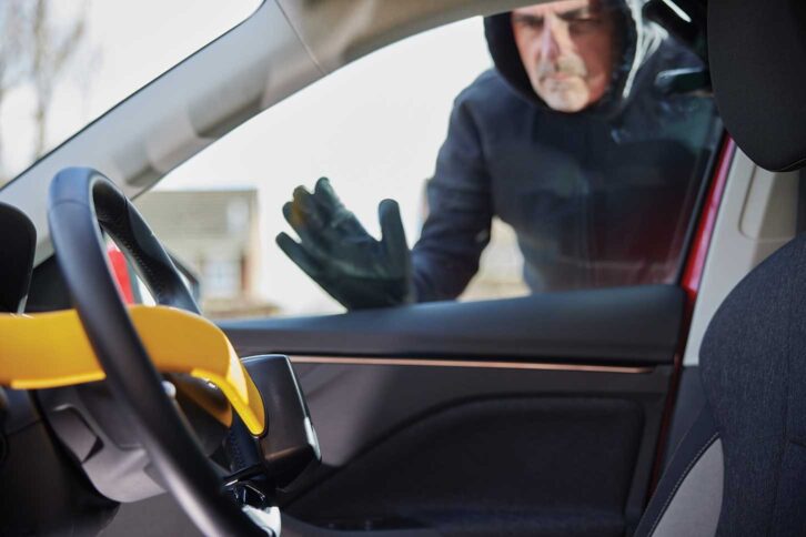 A thief seeing a steering wheel lock on a car