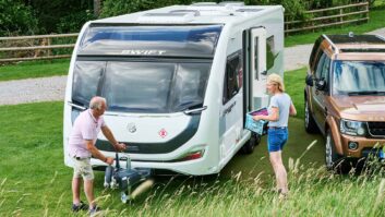 A couple by a pitched up caravan