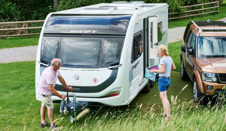 A couple by a pitched up caravan