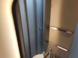 A mirror behind the handbasin in the washroom