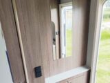 The lit mirror by the entrance door