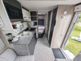 The kitchen area with the bed in the background