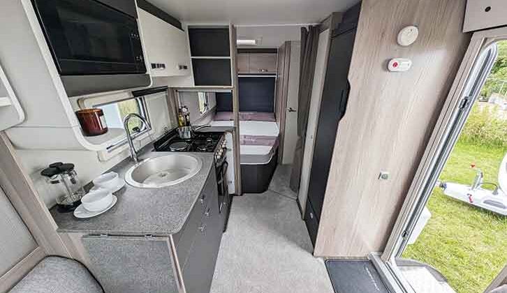 The kitchen area with the bed in the background