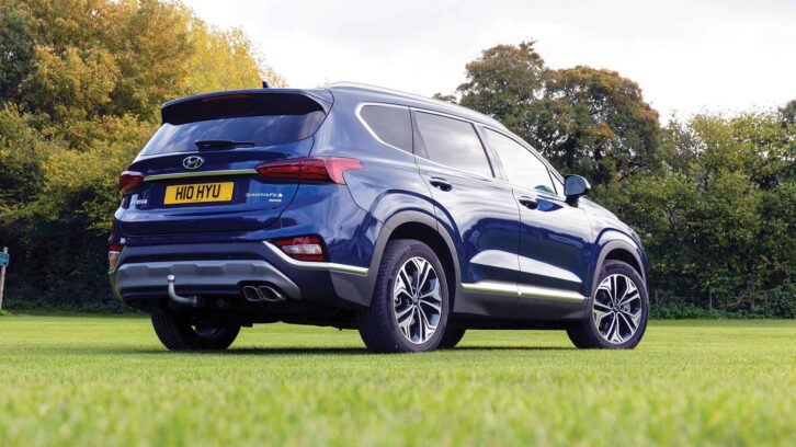 A Hyundai Santa Fe from the rear, parked on grass