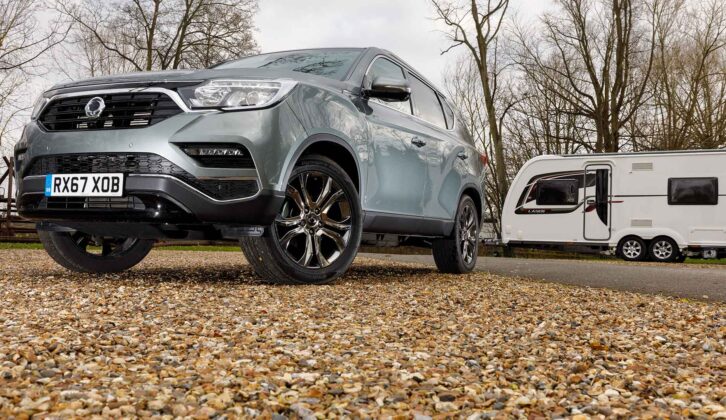 A Ssangyong Rexton parked by a caravan on an autumnal day