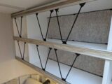 The retainers on the overhead shelving