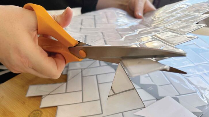 Cutting the tiles with scissors