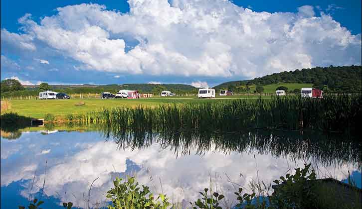 Caravans overlooking water at Hillside Caravan Park