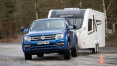 A VW Amarok towing a caravan in wet conditions