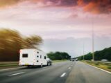 A car towing a caravan on a main road