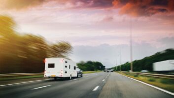 A car towing a caravan on a main road