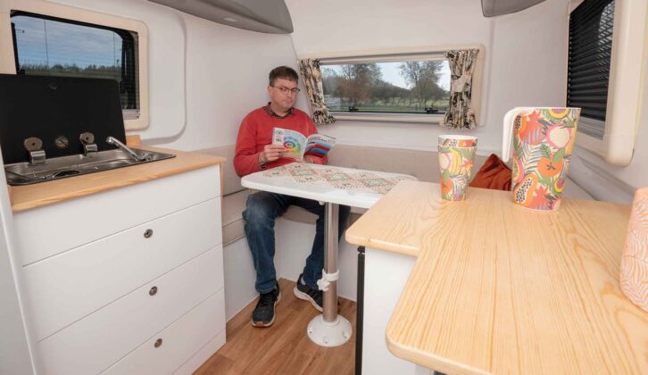 A man sitting in the lounge reading a magazine