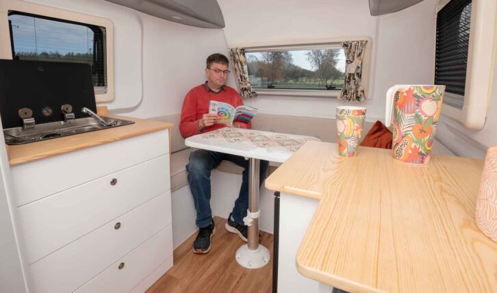 A man sitting in the lounge reading a magazine