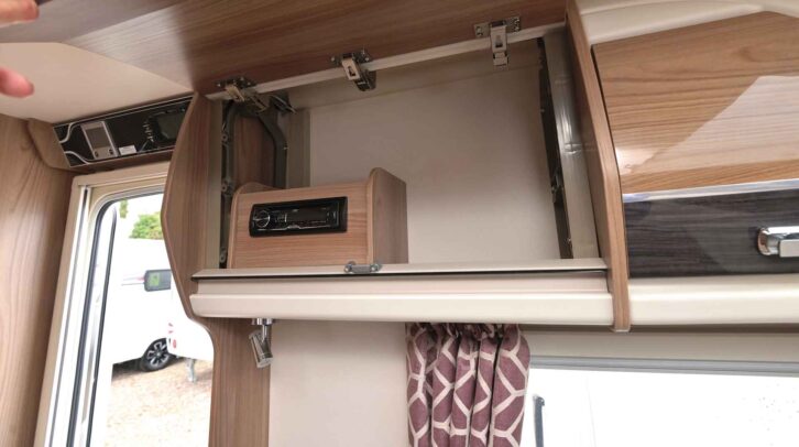 The radio in the overhead locker
