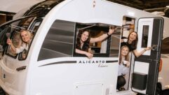 People in a Bailey caravan waving at the camera