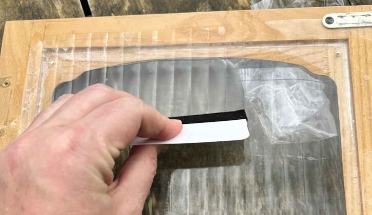 Pushing out bubbles with squeegee