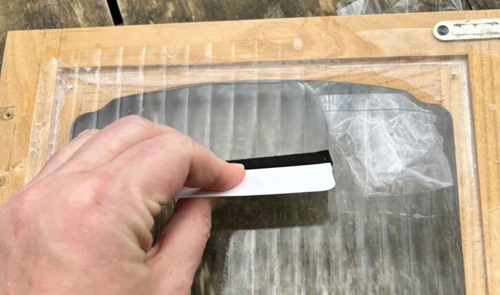 Pushing out bubbles with squeegee