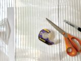 Fluted glass-effect film with scissors and tape