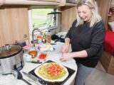 A woman cooking in a caravan