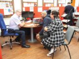 Sales staff talking to customers