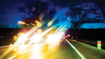 An image from the driver's perspective showing oncoming traffic with headlight glare