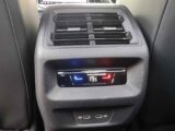 The air vents pointing out to the rear seats