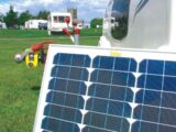 Freestanding solar panel in use on site with a caravan in the background