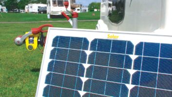 Freestanding solar panel in use on site with a caravan in the background