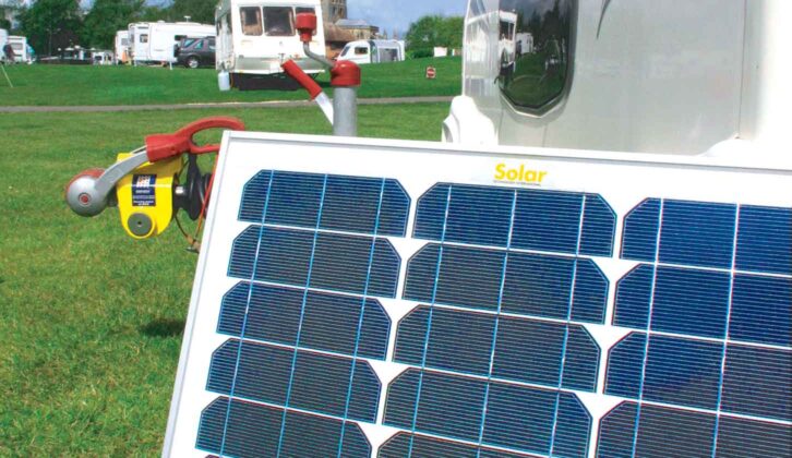 Freestanding solar panel in use on site with a caravan in the background