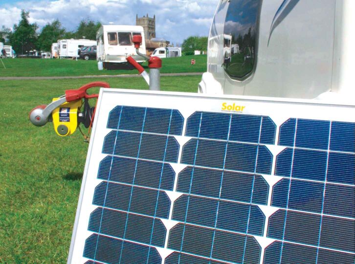 Freestanding solar panel in use on site with a caravan in the background
