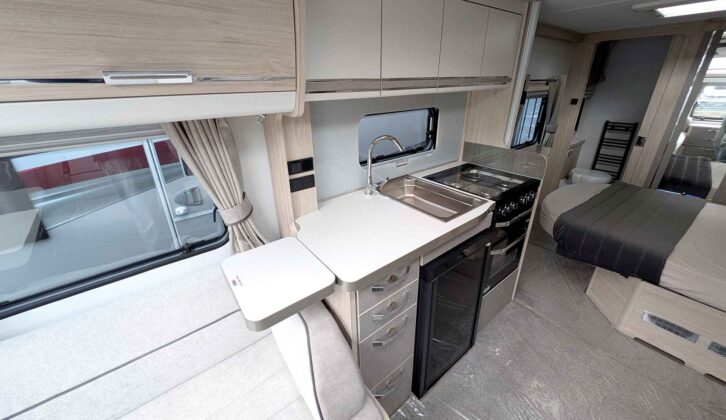 The four-burner dual-fuel hob, separate oven and grill, and half-height fridge in the kitchen