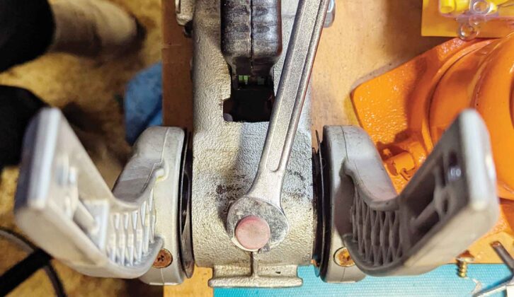 Using a 14mm spanner to ease out the old front pad