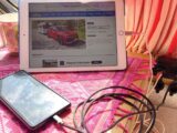 A mobile phone and an iPad charging in a caravan