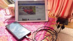 A mobile phone and an iPad charging in a caravan