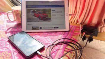 A mobile phone and an iPad charging in a caravan