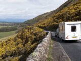 A caravan being towed down a country road