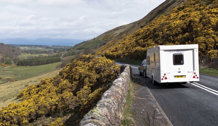 A caravan being towed down a country road