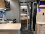 The l-shaped kitchen and rear island bed in the Bailey Pegasus Black Edition Messina
