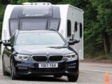 A BMW 5 Series Touring towing a caravan