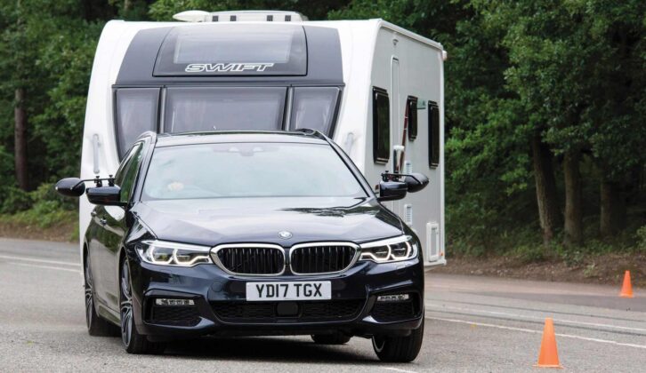 A BMW 5 Series Touring towing a caravan