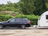 The BMW hitched up to a caravan side-on