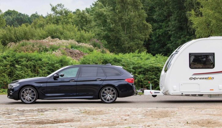The BMW hitched up to a caravan side-on