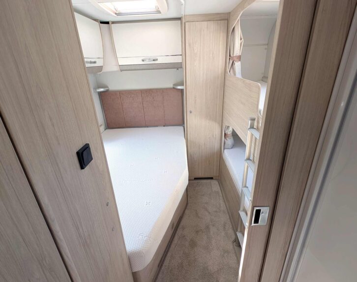 The fixed double bed and bunk beds at the rear of the 868