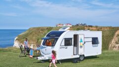 Family outside a Swift Sprite caravan
