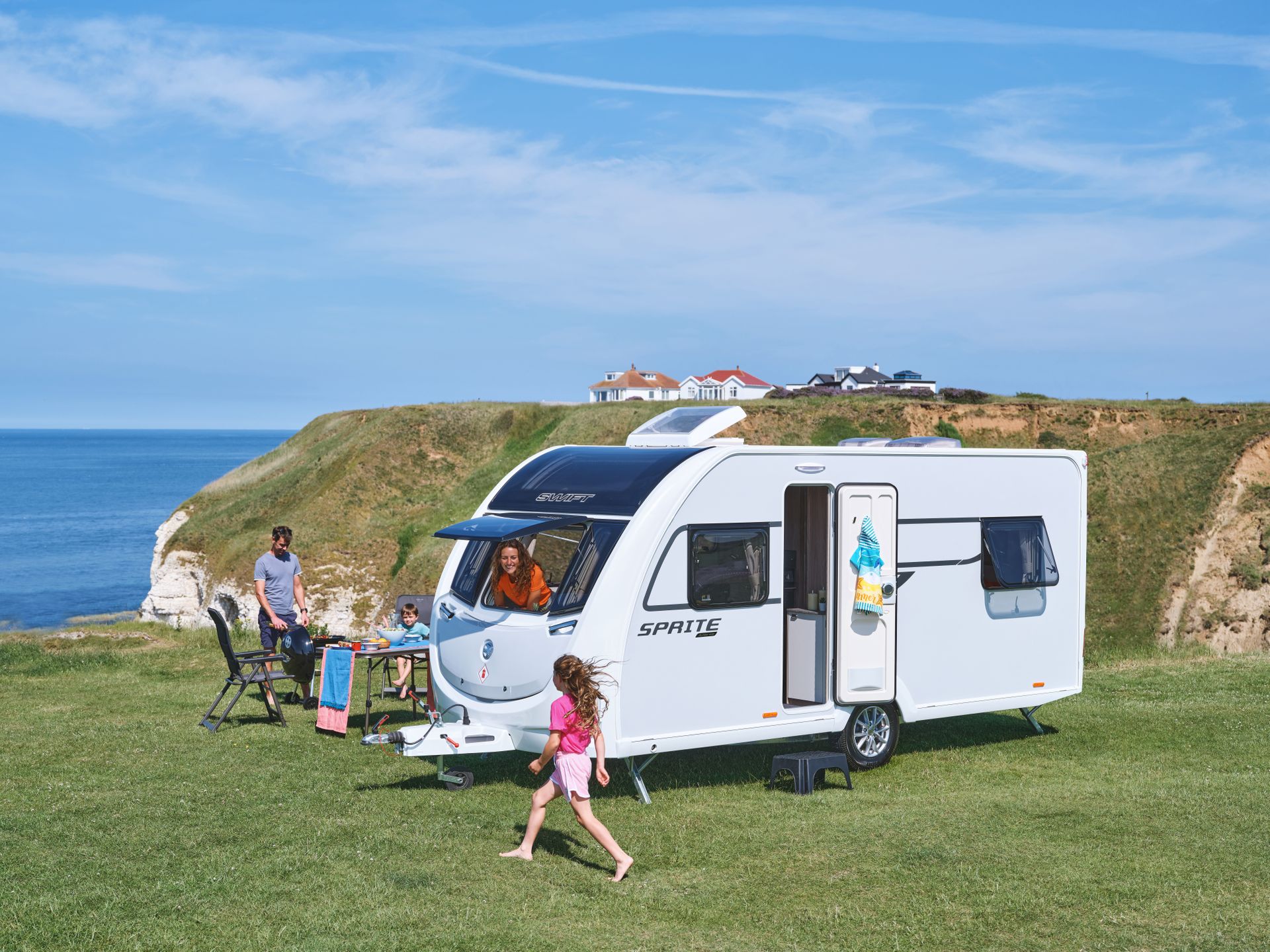 Family outside a Swift Sprite caravan