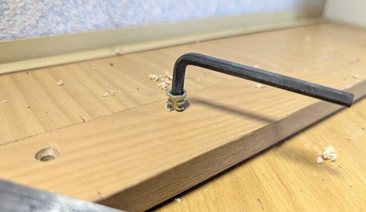 Driving a threaded nut into the drawer front